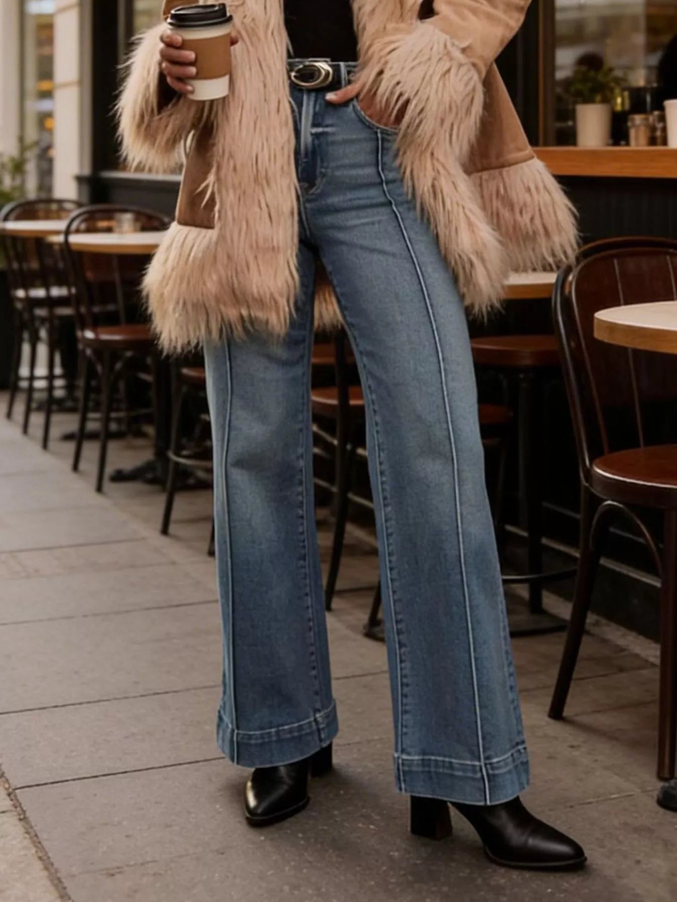 Light blue high-waisted flare leg denim jeans by Trendsi, showcasing fit and classic style in a fashion-forward design.