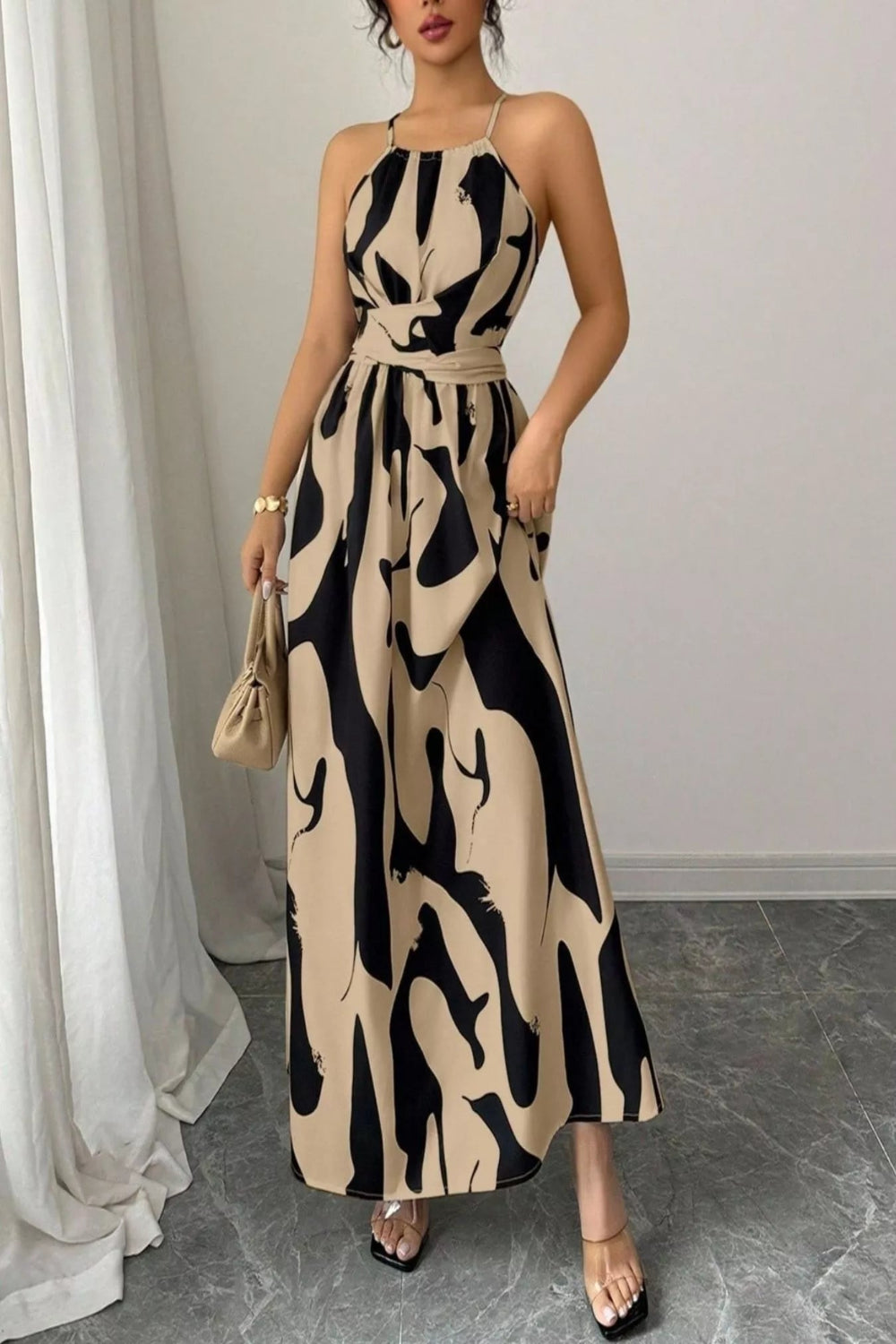 Abstract print halter neck maxi dress from Trendsi, flowing dress with bold patterns and a stylish halter neckline.