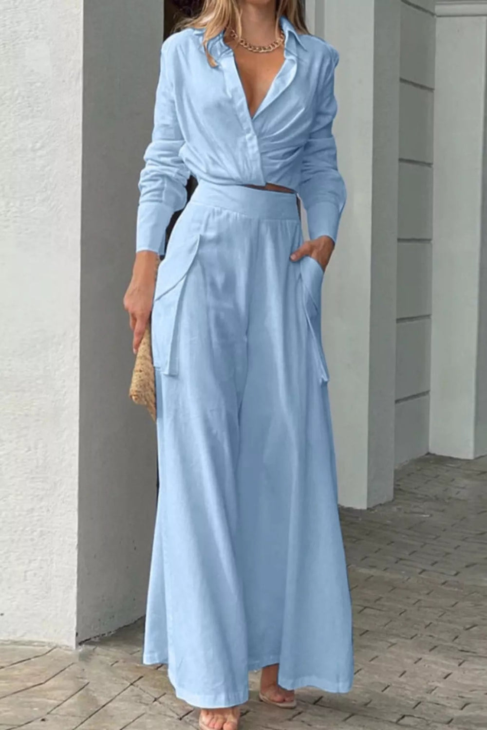 Button front shirt with chest pocket and wide-leg pants set by Trendsi, featuring a stylish, casual look in soft fabric.