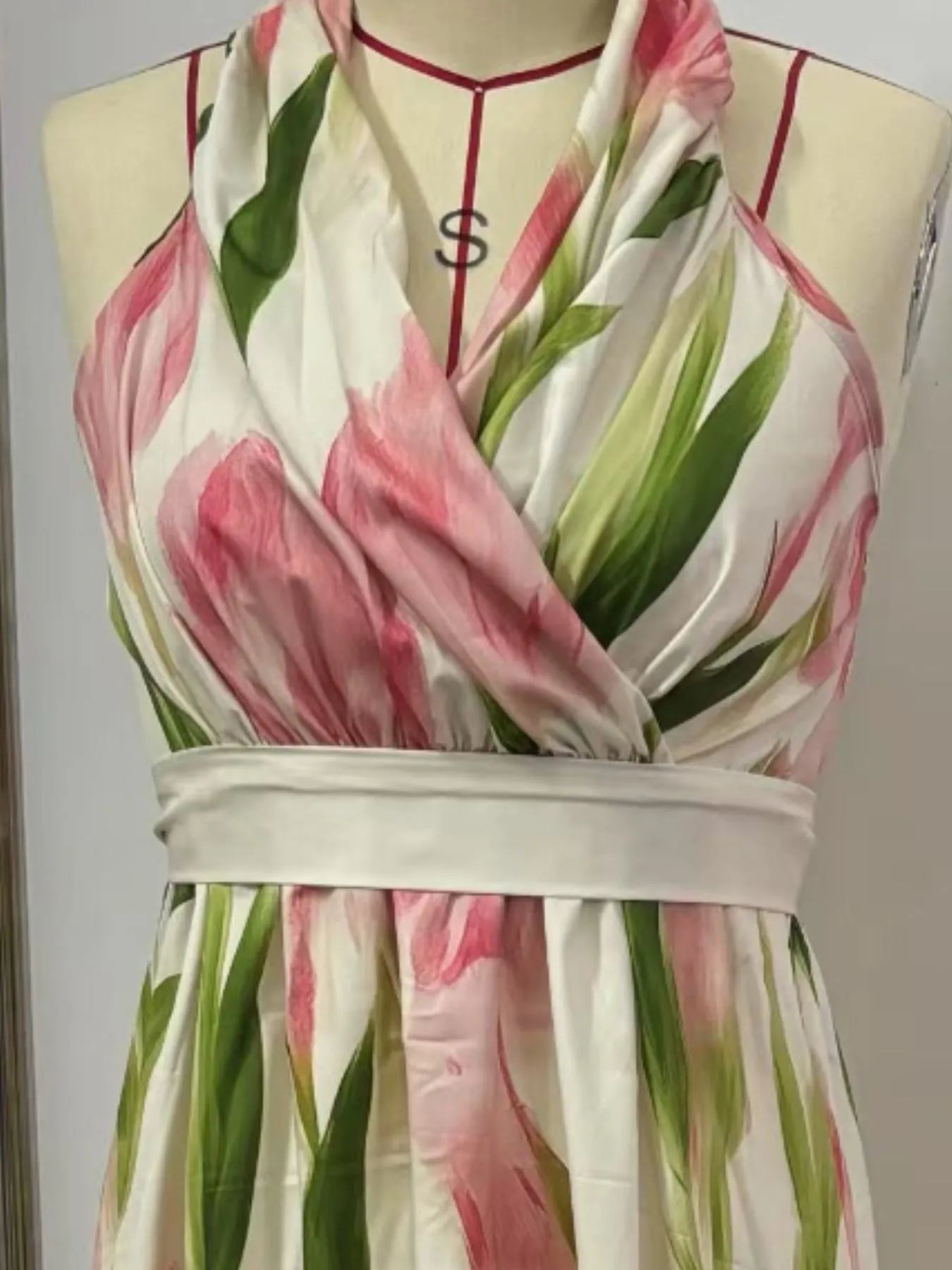 Floral print halter neck maxi dress by Trendsi featuring a flowing silhouette and vibrant floral pattern in natural light.