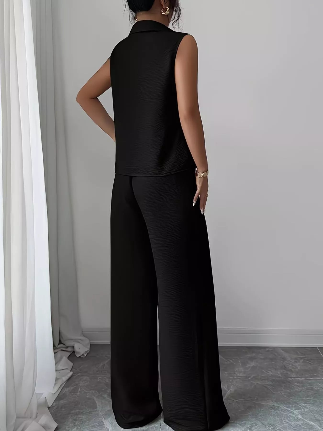 V-neck sleeveless top and wide-leg pants set by Trendsi, featuring a stylish, lightweight fabric with a relaxed fit.