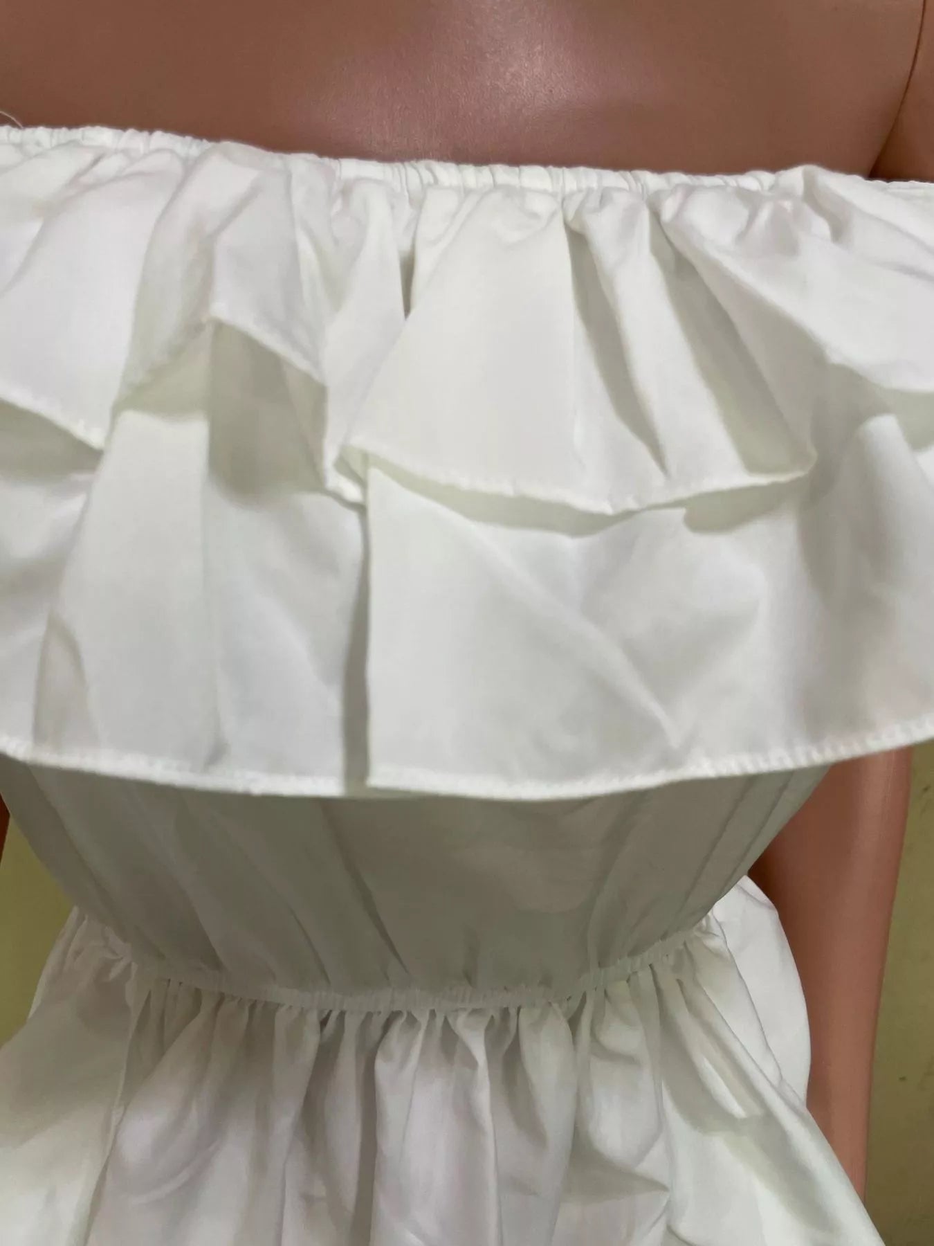 Ruffle off-shoulder high-low blouse from Trendsi, featuring flowy fabric and elegant design, perfect for stylish tops and blouses.