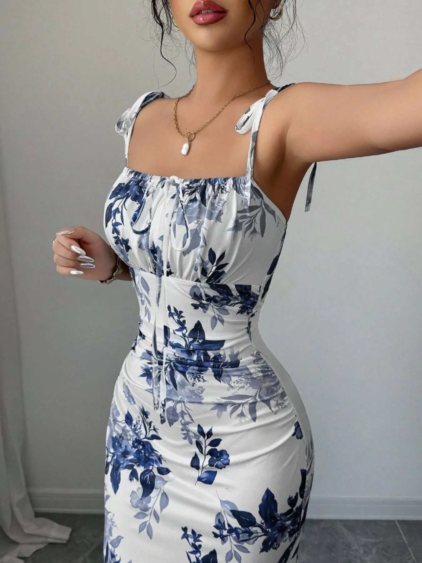 Printed tie strap slit maxi dress from Trendsi featuring a flowy silhouette, front slit, and adjustable straps.