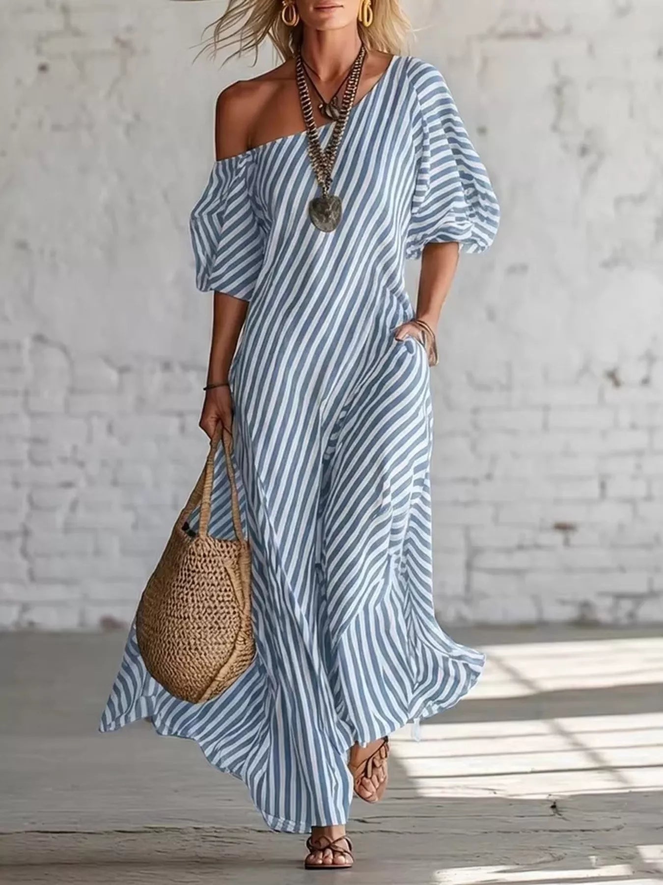 Striped one-shoulder maxi dress from Trendsi featuring a flowing design and bold horizontal stripe pattern.