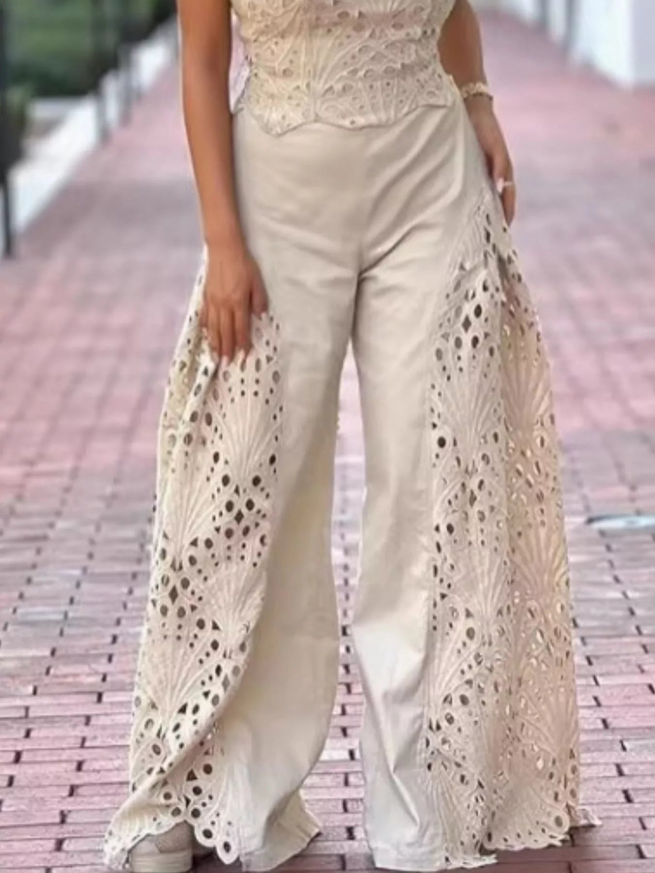 Trendsi hollow-out tube top and matching pants set, stylish 2-piece outfit with cut-out details, black fabric, and modern design.