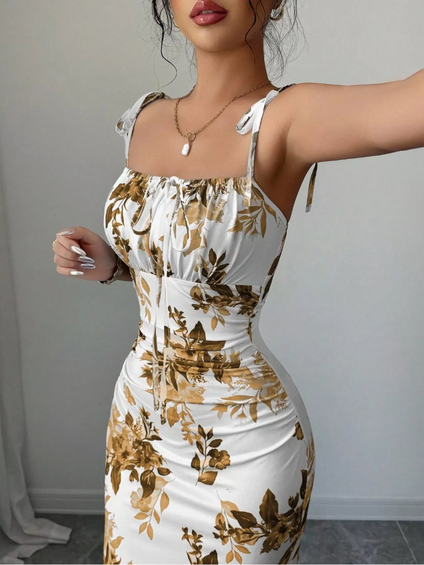 Printed tie strap slit maxi dress from Trendsi featuring a flowy silhouette, adjustable straps, and a side slit for a stylish look.