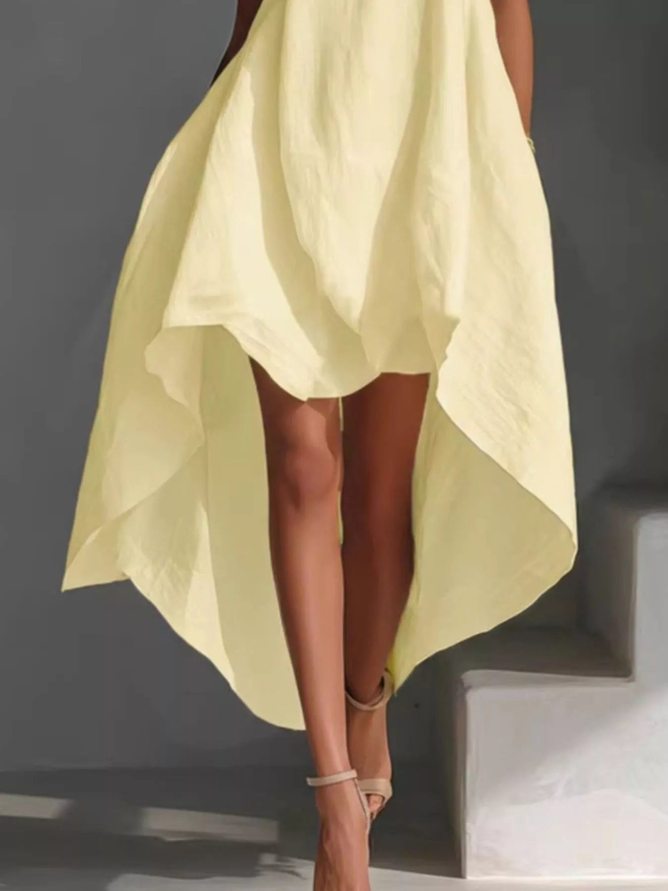 Sleeveless high-low round neck dress from Trendsi, featuring a flowy silhouette and casual stylish design.