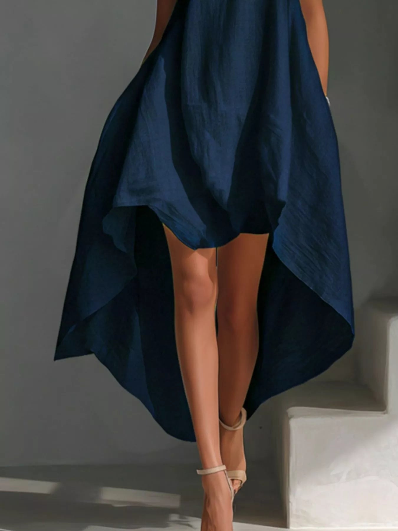 Sleeveless high-low round neck dress from Trendsi, featuring a stylish and flowy design perfect for casual or dressy occasions.