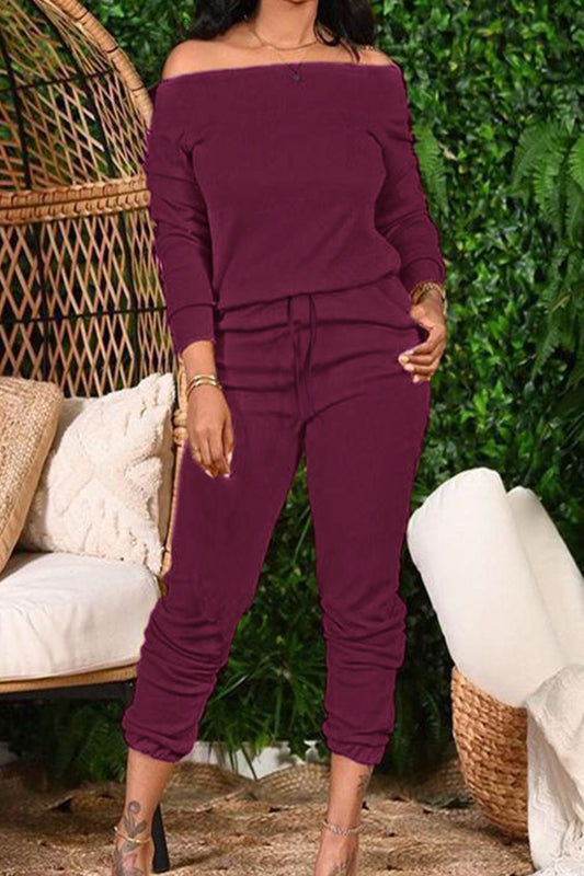 Burgundy off-shoulder top and cropped pants set from Trendsi, styled on a model with a casual, trendy look.