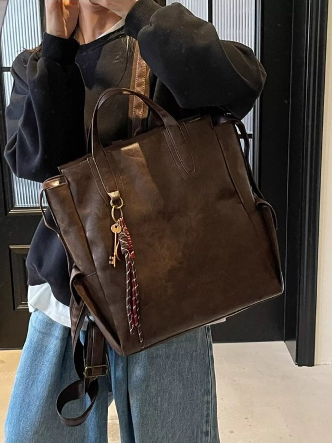 Vintage leather convertible backpack bag by Trendsi, showing the stylish brown leather backpack with adjustable straps.