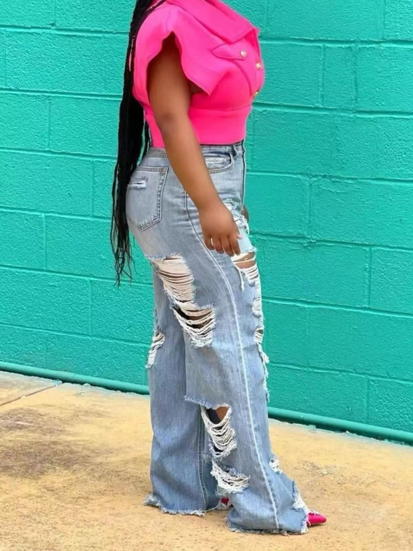 Distressed wide-leg denim jeans from Trendsi, featuring a relaxed fit and frayed hem, shown on a model.