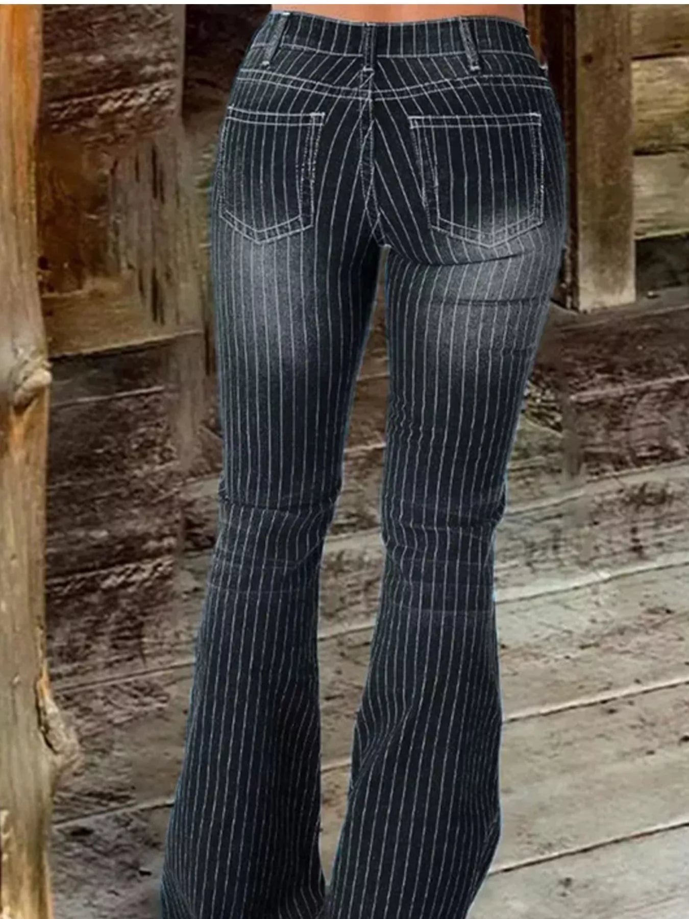 Striped button fly flare jeans in denim featuring bold vertical stripes and classic flare silhouette by Trendsi.