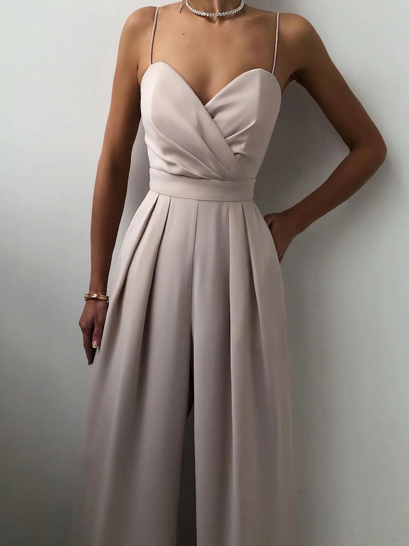 Trendsi spaghetti strap wide-leg jumpsuit with a fitted bodice and flowing pant legs, perfect for casual or dressy occasions.
