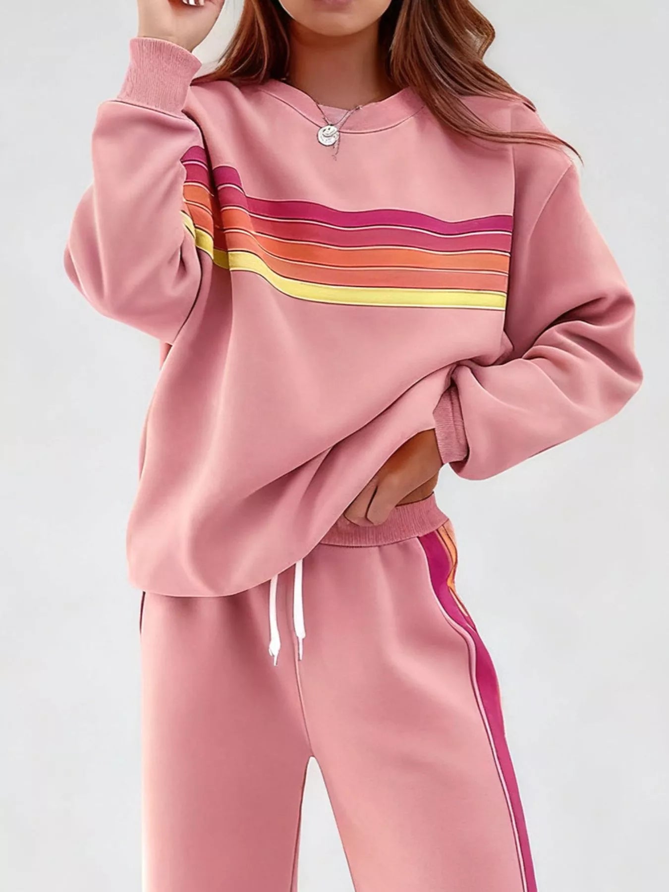 Striped round neck sweatshirt and matching pants set by Trendsi, featuring a casual, comfortable fit and colorful stripe pattern.