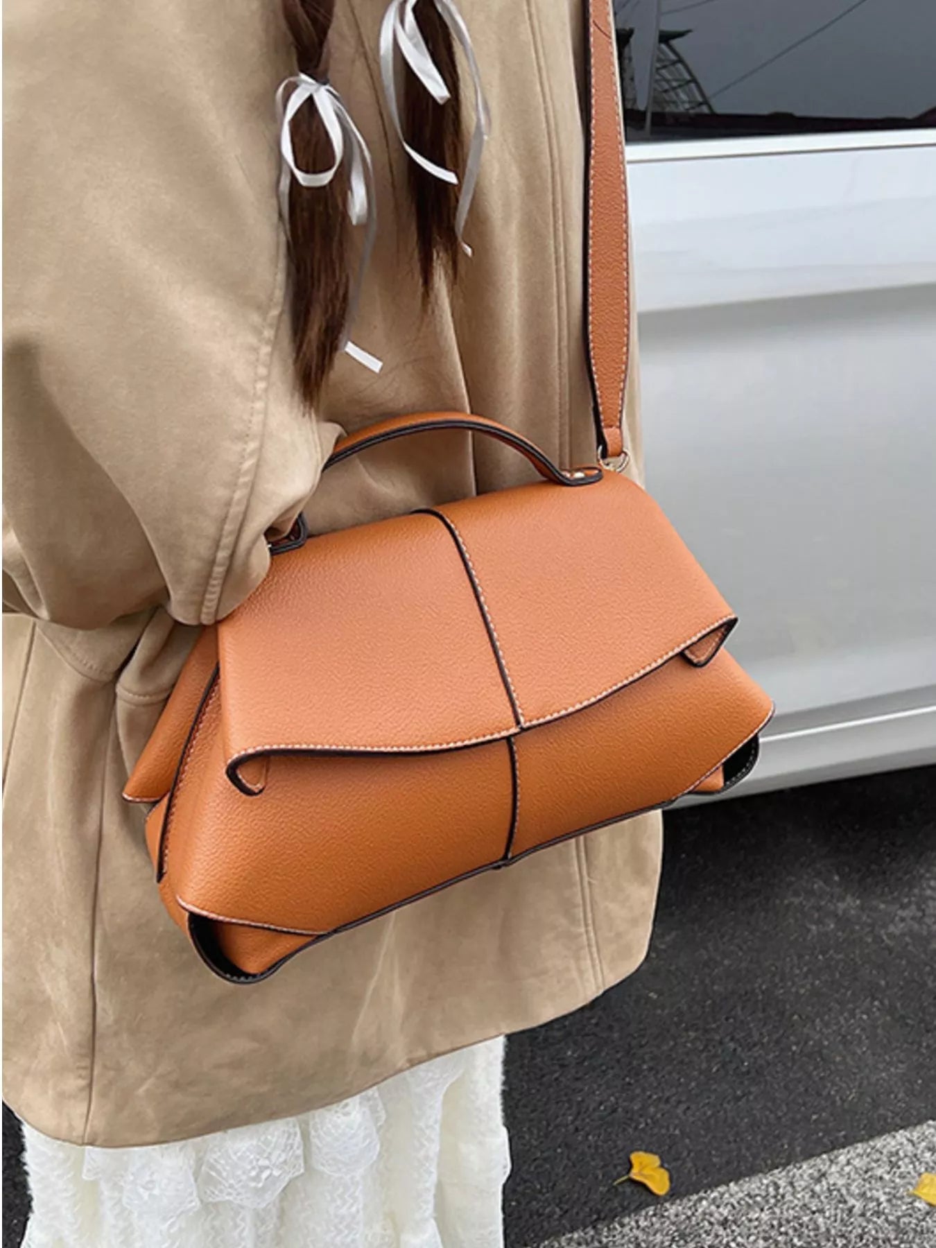 Geometric flap shoulder bag from Trendsi featuring a modern, structured handbag with a flap closure and stylish design.