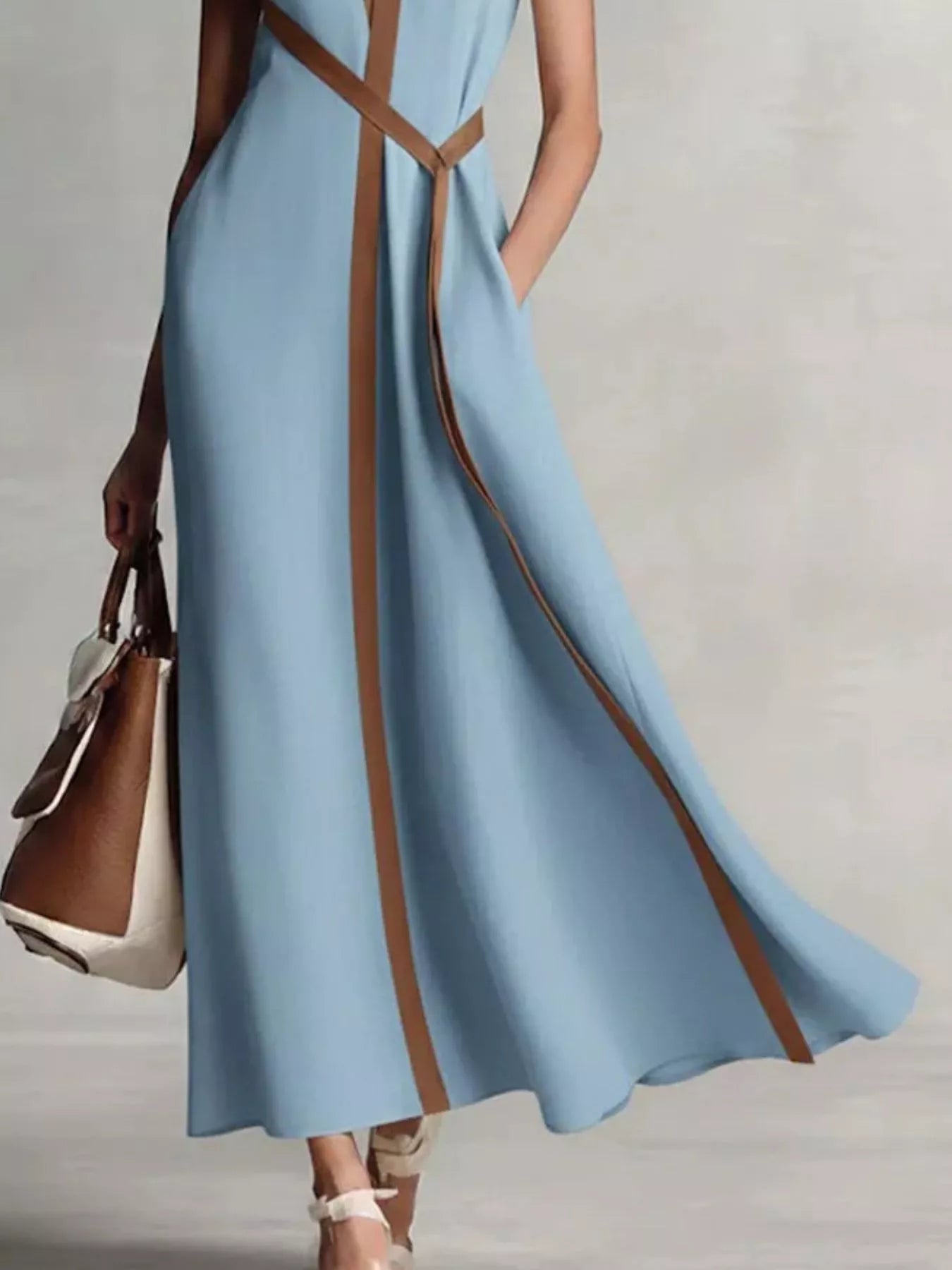 Black sleeveless maxi dress with contrast trim from Trendsi featuring a flowing silhouette and elegant design.