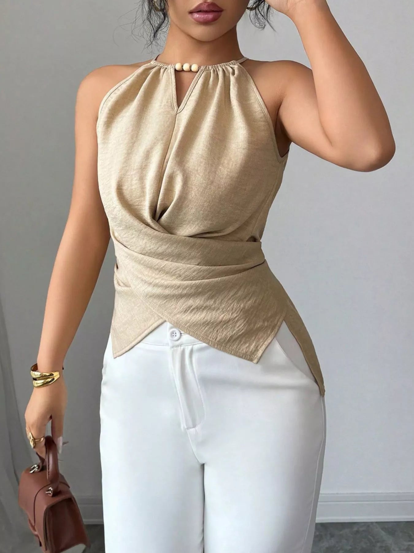 Halter neck crisscross cami blouse from Trendsi, featuring a stylish design and lightweight fabric, perfect for casual wear.