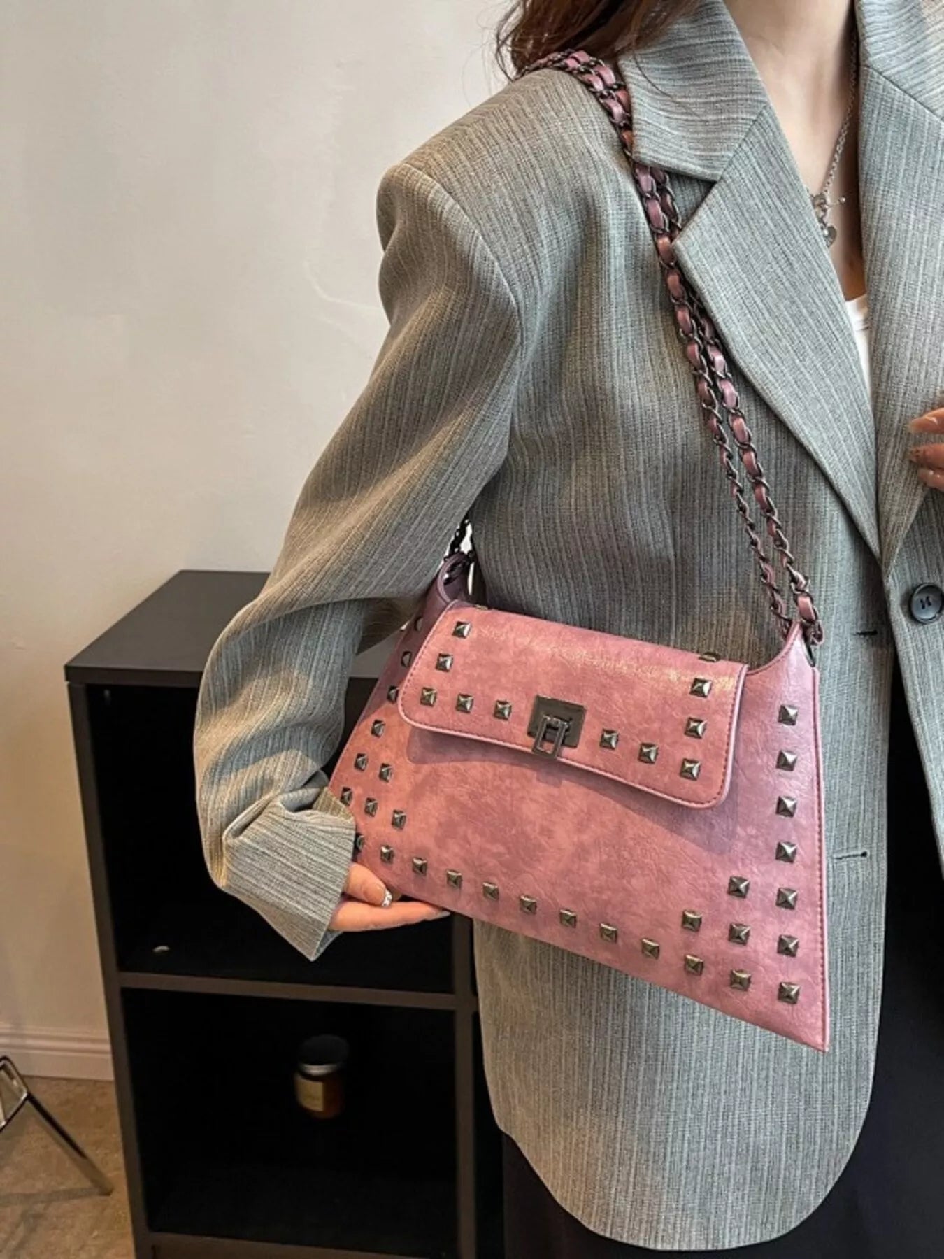 Studded flap chain shoulder bag from Trendsi, featuring a stylish design with metal studs and a chain strap.