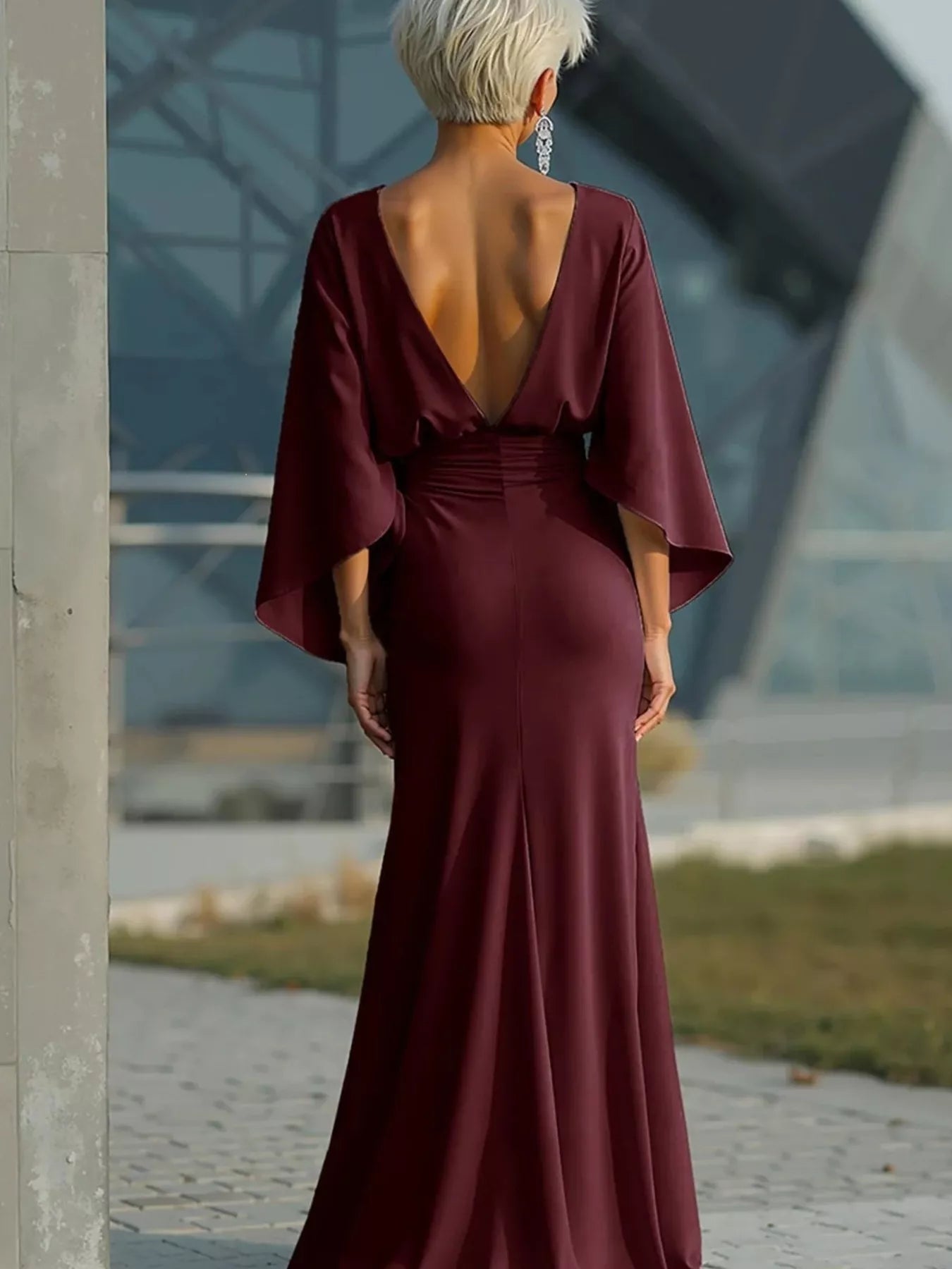 Batwing sleeve ruched evening dress by Trendsi featuring elegant draped fabric and a flattering fit.
