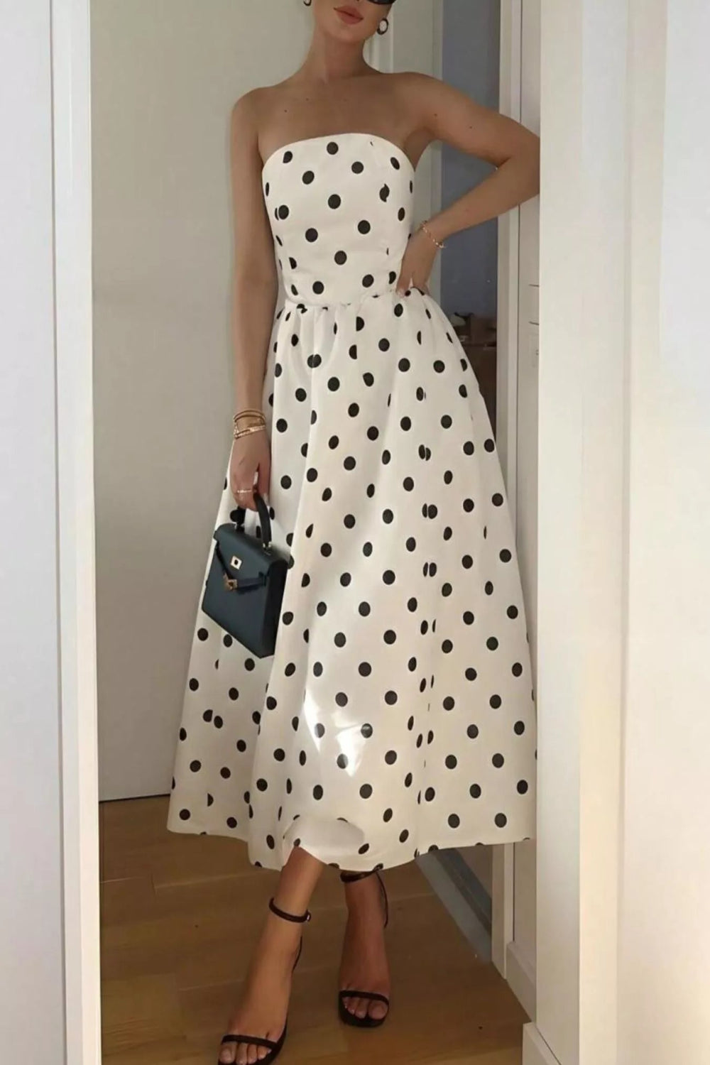 Polka dot strapless midi dress by Trendsi featuring a fitted bodice and flowing skirt, perfect for summer or casual occasions.