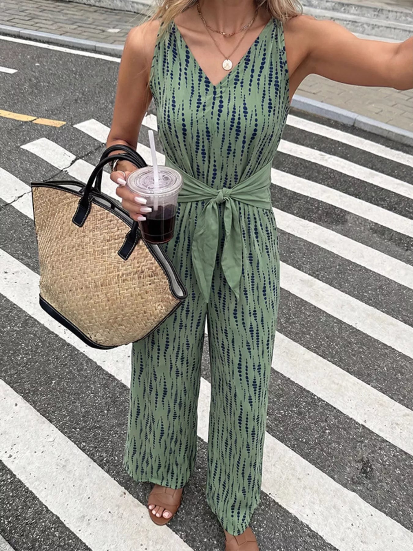 Printed wide leg jumpsuit by Trendsi featuring a flowing design and bold pattern, perfect for stylish casual wear.