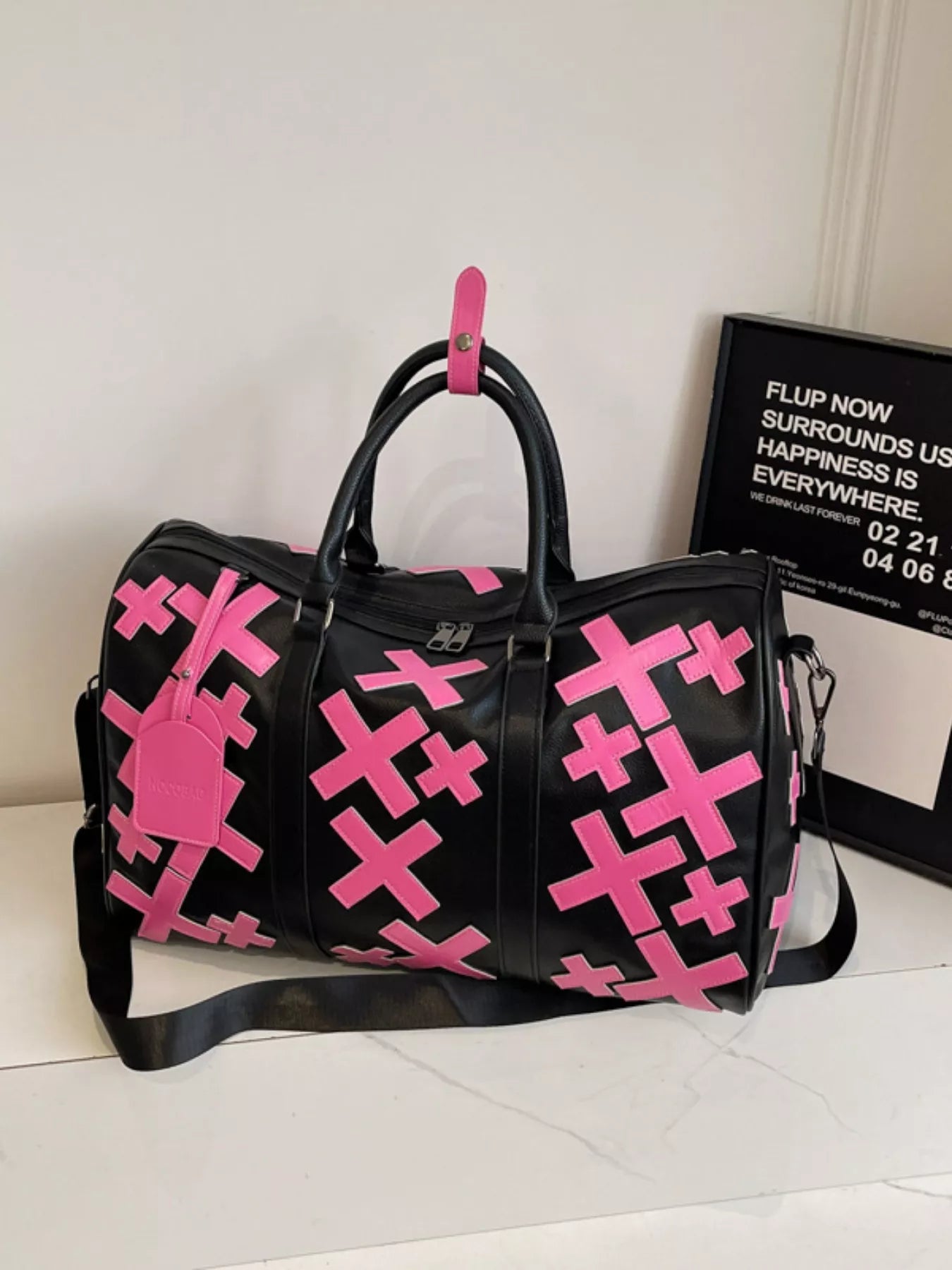Colorful cross pattern travel duffel bag from Trendsi, made of durable fabric with sturdy handles and vibrant design.