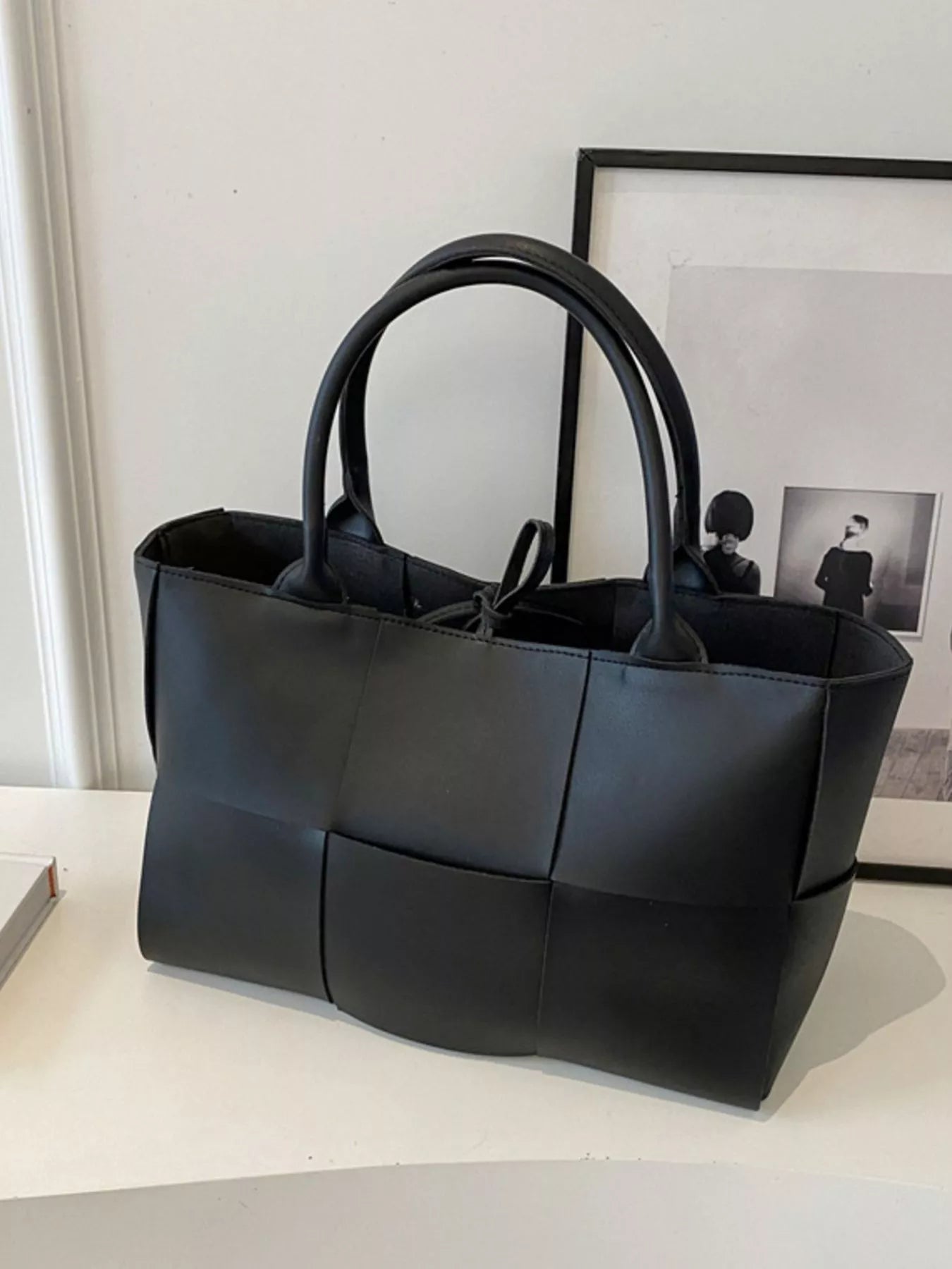 Woven leather tote handbag with dual handles and spacious interior, stylishly crafted by Trendsi for everyday use.