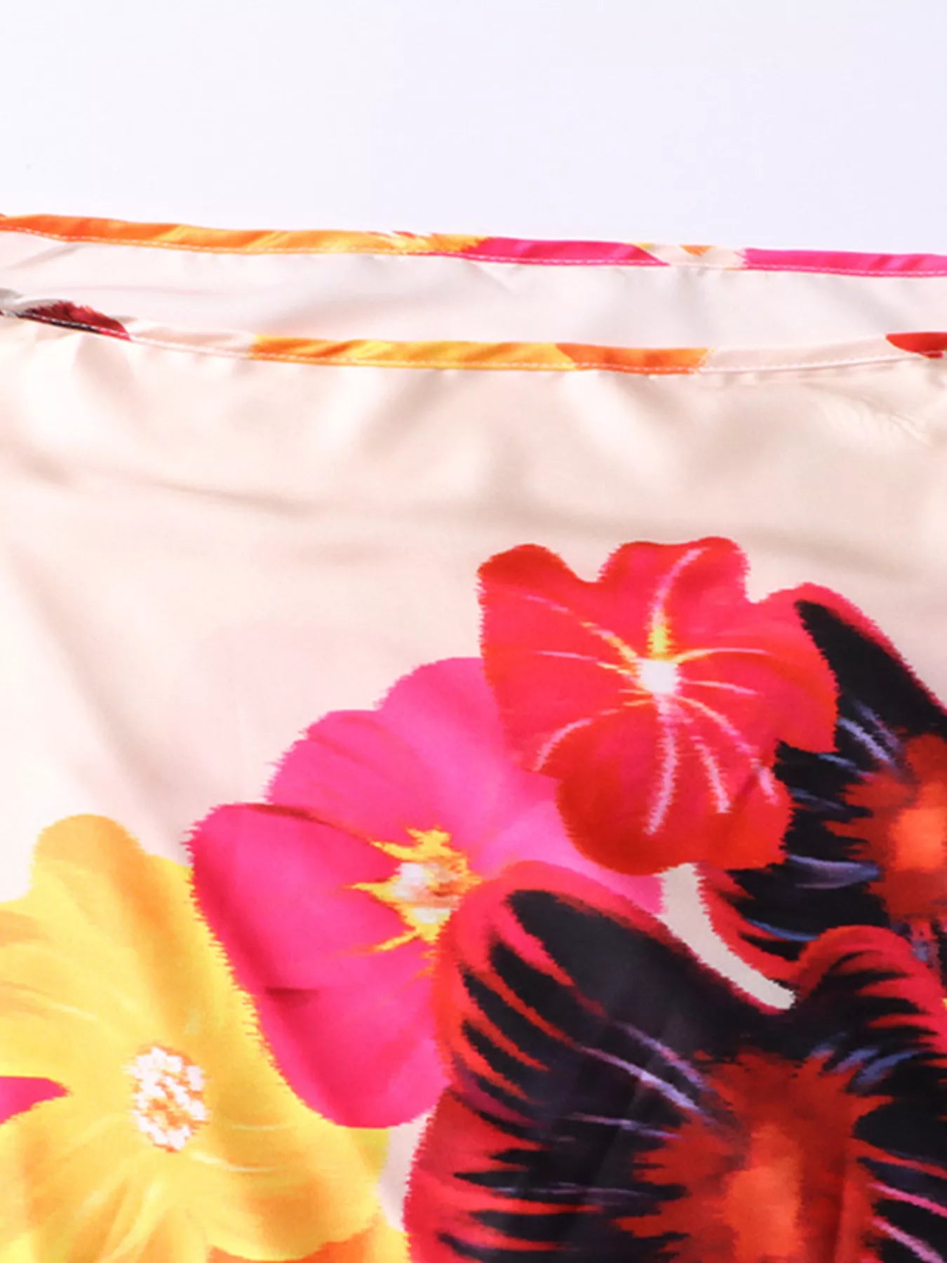 Floral print off-shoulder top and pants set from Trendsi, featuring a vibrant, lightweight fabric with a relaxed fit.