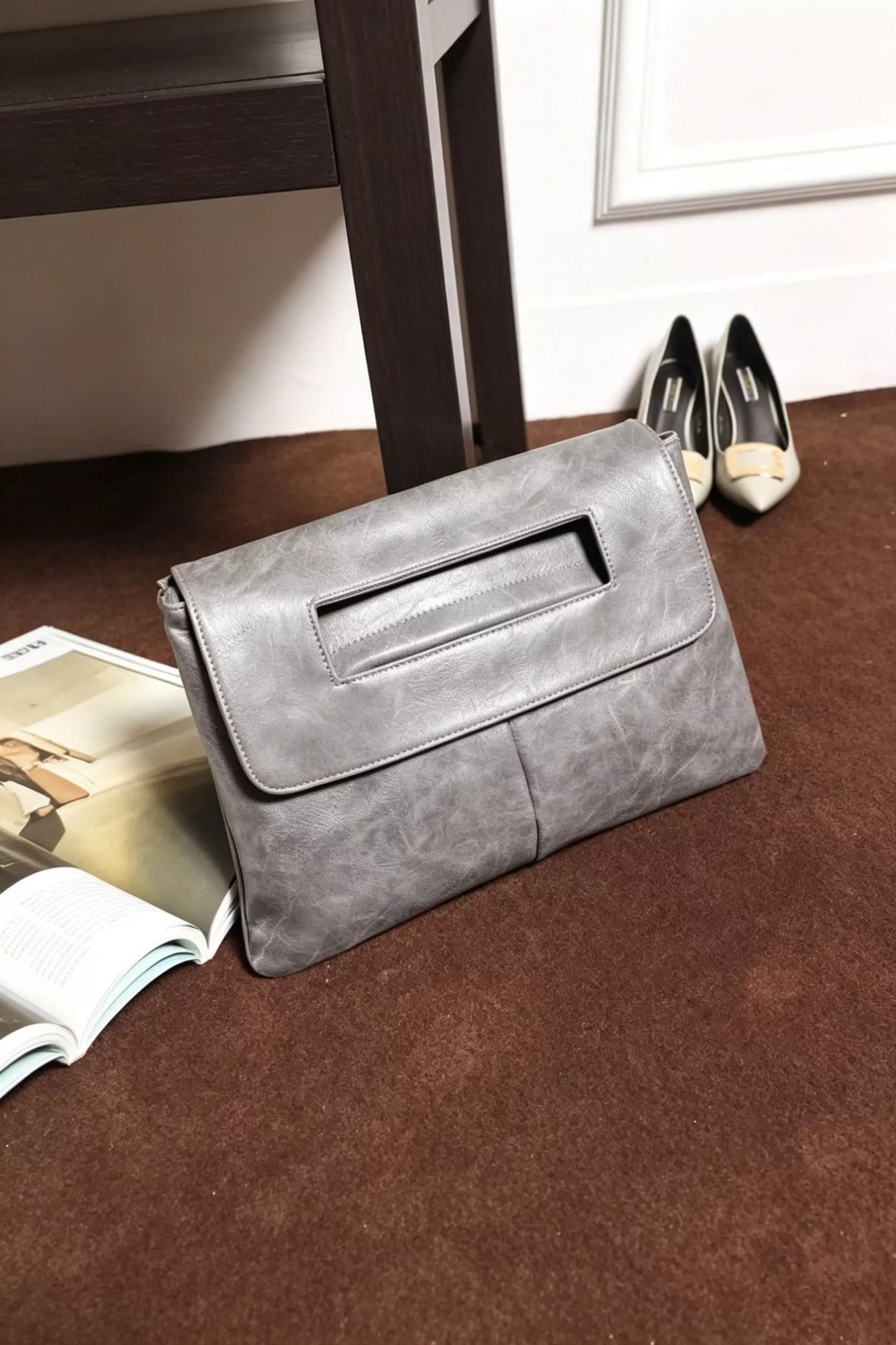 Vintage style envelope clutch handbag by Trendsi, featuring a sleek leather design with a fold-over flap and minimalist closure.