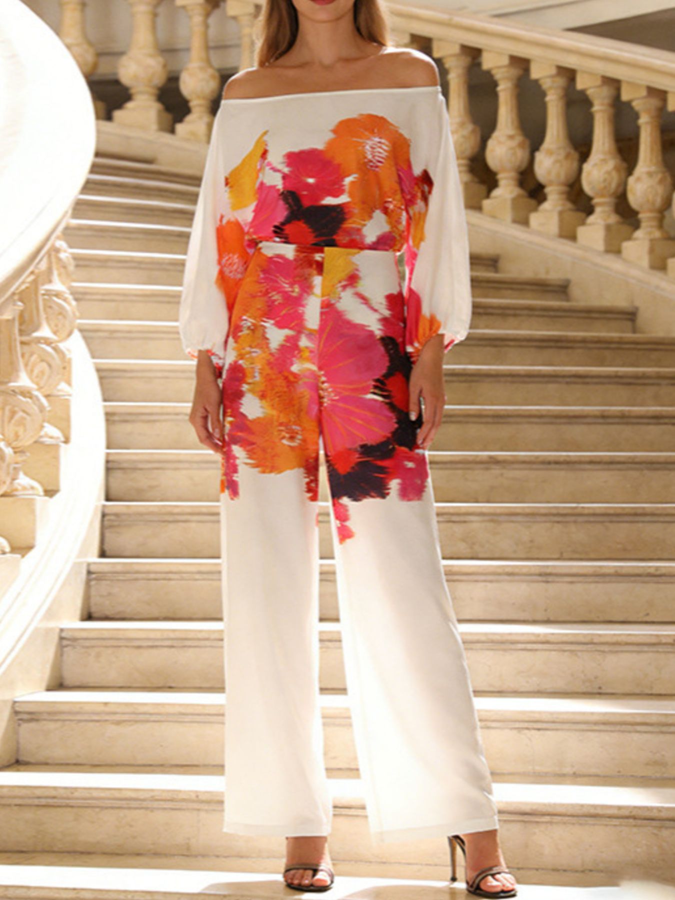 Floral print off-shoulder top and matching pants set by Trendsi, showcasing lightweight fabric and vibrant floral design.